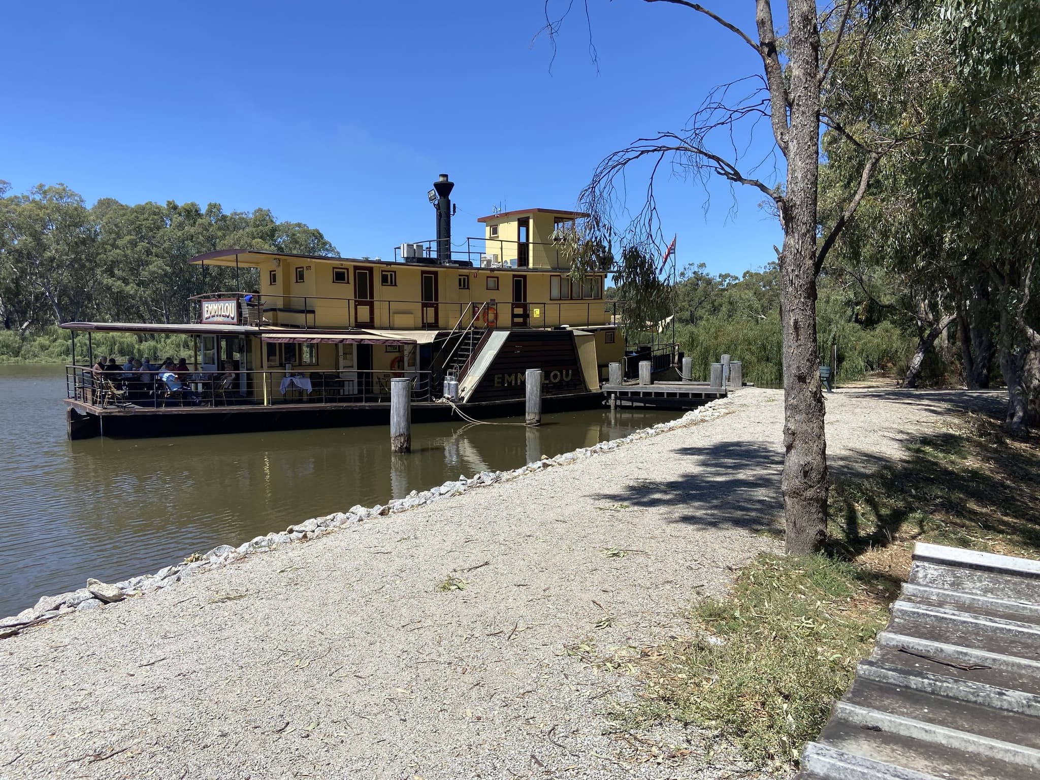 Paddlesteamer Emmylou moored on the Murray River beside the concrete boat ramp at Torrumbarry Weir Holiday Park
